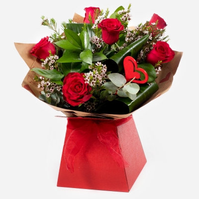 Kissing Booth
 - Who could resist you after receiving this selection of the beautiful red roses matched to the finest seasonal foliage.
